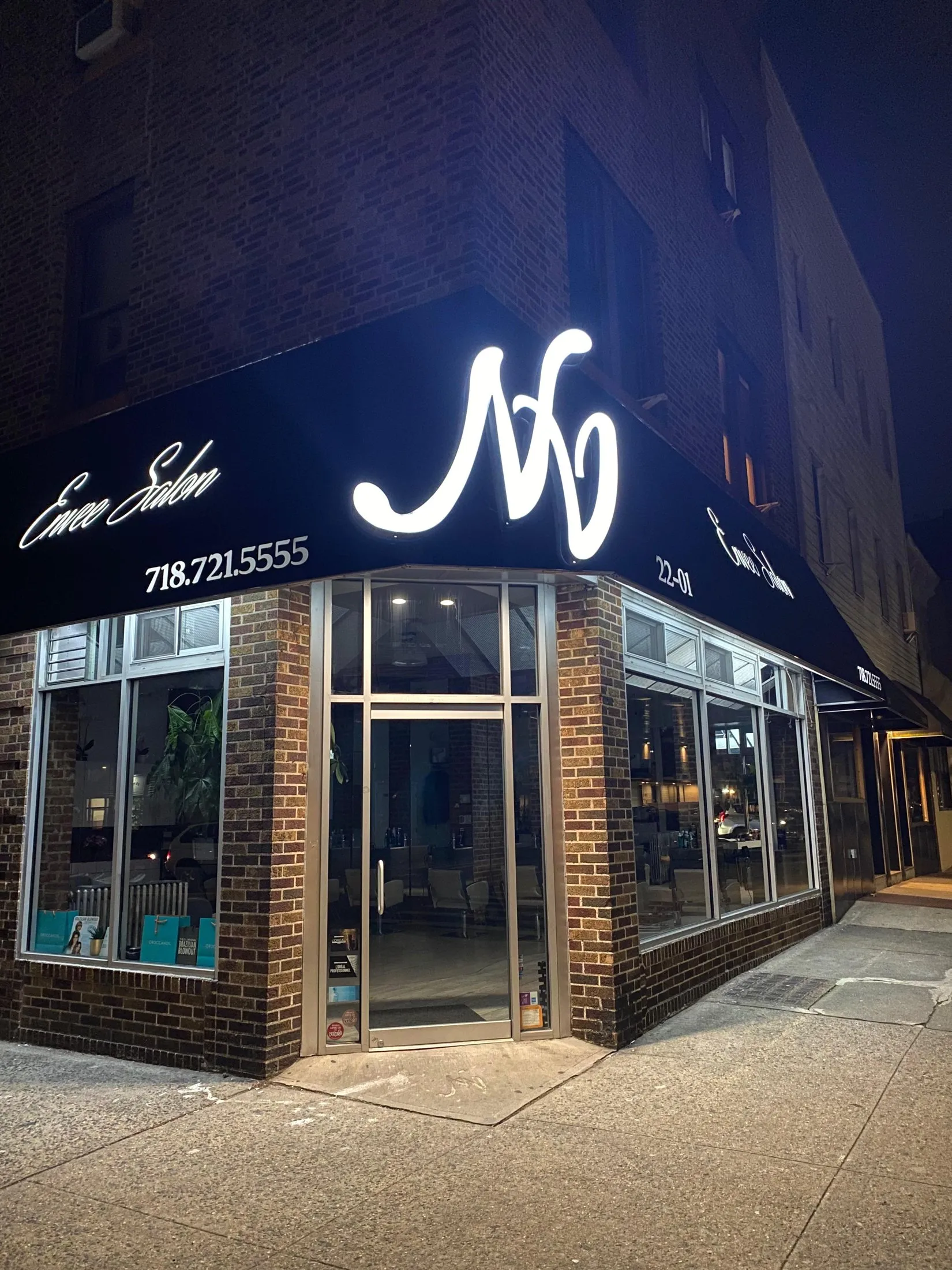 Envee Salon storefront on Steinway Street, Astoria at night